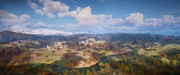 Assassin's Creed Valhalla landscape with snow-capped mountains and autumn trees