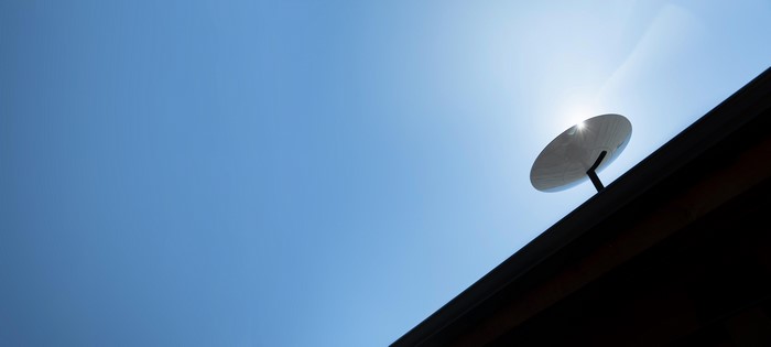 Starlink satellite dish on roof against blue sky