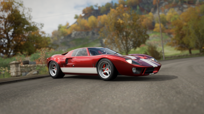 Red Ford GT40 driving on a road
