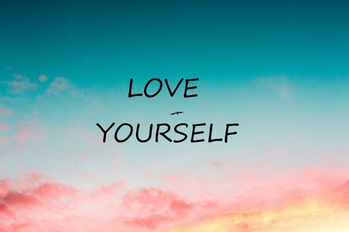 Love Yourself quote on a sky background
