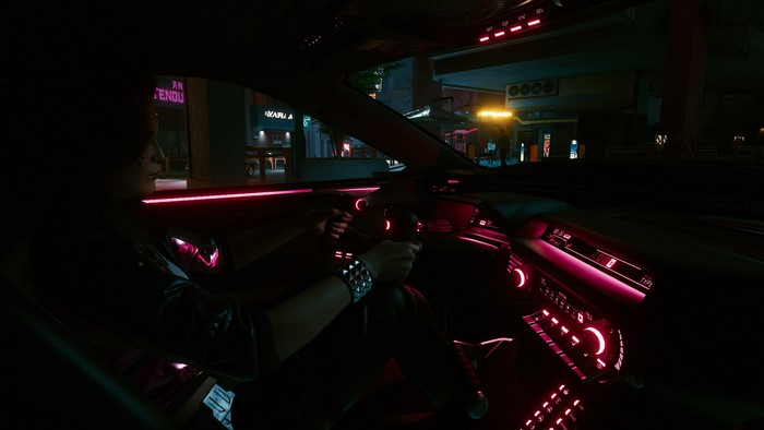 Rogue from Cyberpunk 2077 driving a car at night
