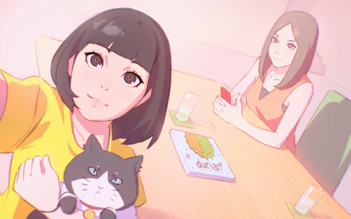 Two women and a cat at a table
