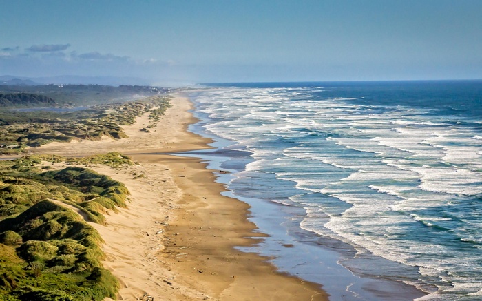 Sandy beach with dunes and ocean waves