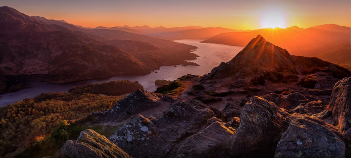 Sunset over mountains and a lake