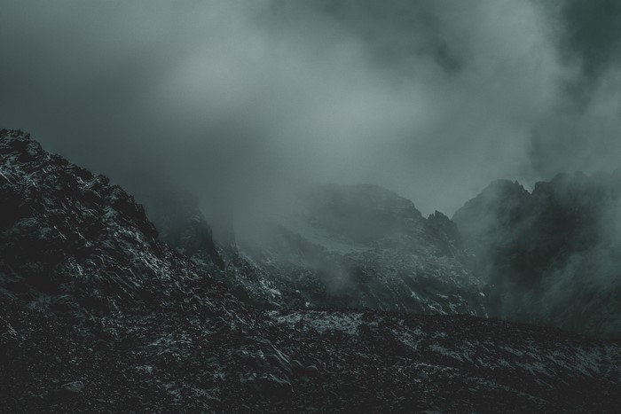 Misty mountains with rocky terrain