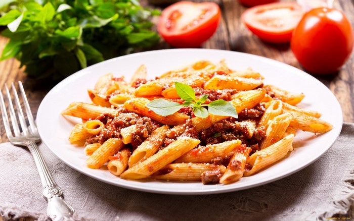 Penne pasta with meat sauce and basil
