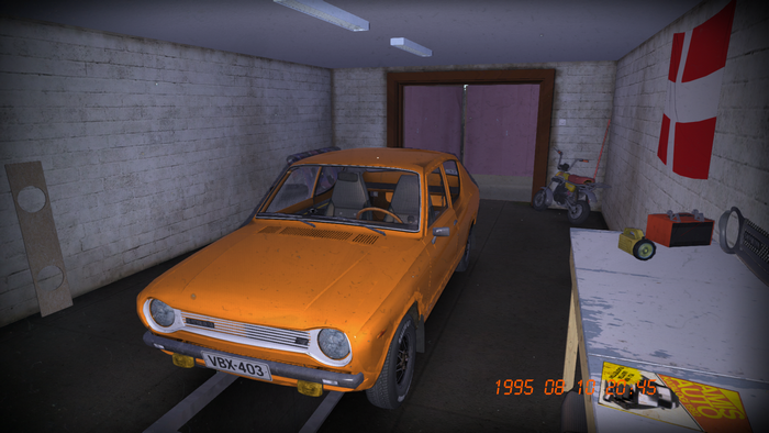 Orange car in a garage with a motorcycle