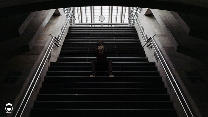 Anime man sitting on stairs at train station with clock