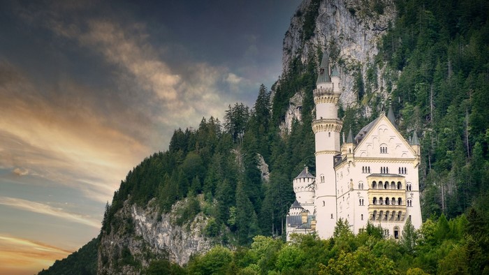 Neuschwanstein Castle in Germany with forest and mountains