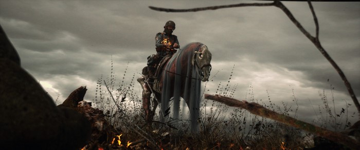 Undead rider on a horse in a desolate landscape