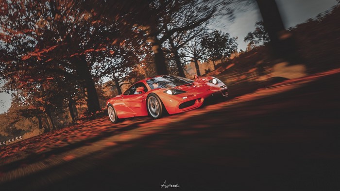 McLaren F1 driving on a forest road in autumn