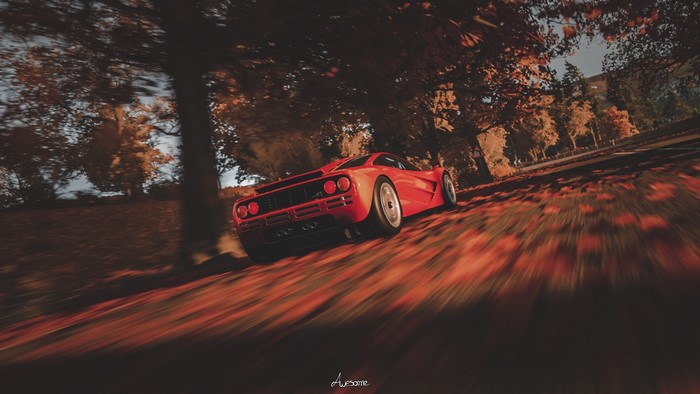 Red McLaren F1 driving through autumn forest in Forza Horizon 4