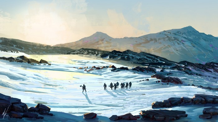 Group of people walking through a snowy mountain landscape
