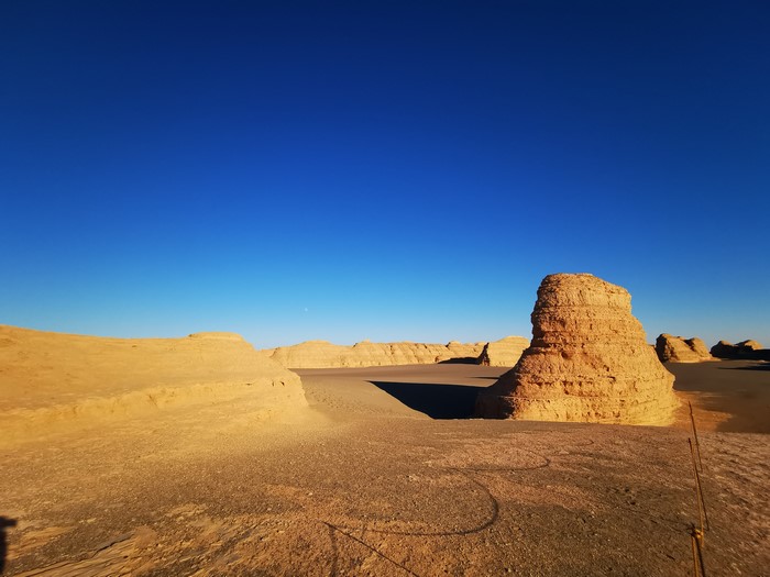 Desert landscape with rock formations under a clear blue sky