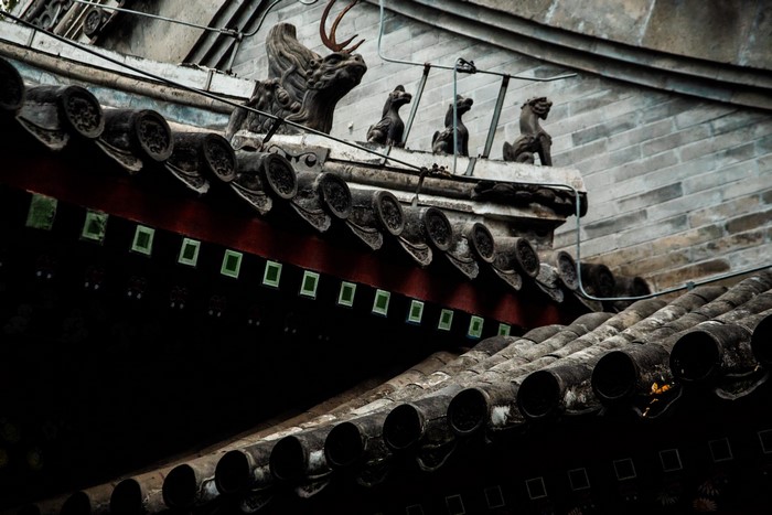 Traditional Chinese rooftops with dragon and lion statues