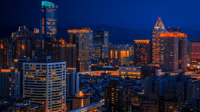 City skyline at night with illuminated buildings