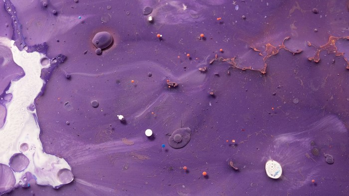 Abstract purple and white fluid texture with small spheres