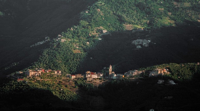Village nestled in a lush green mountain landscape
