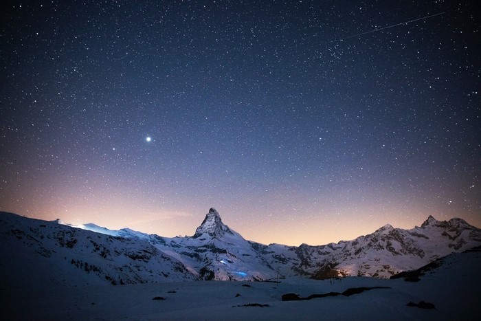 Starry night over snow-covered Matterhorn mountains