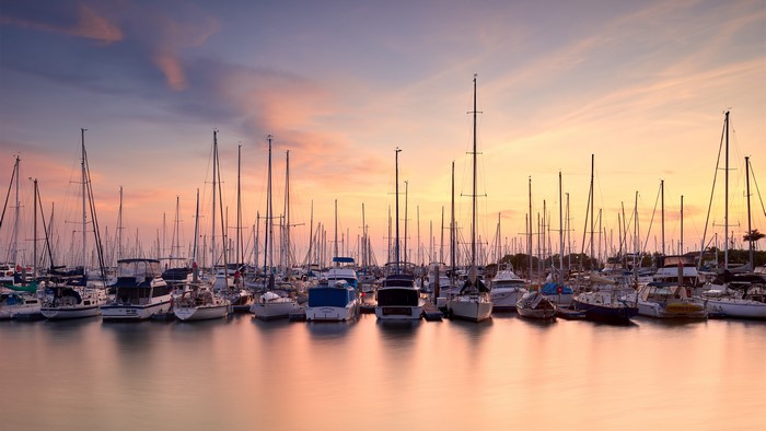 Yachts in a harbor at sunrise or sunset