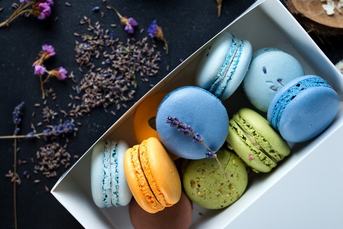 Colorful macarons in a box with lavender