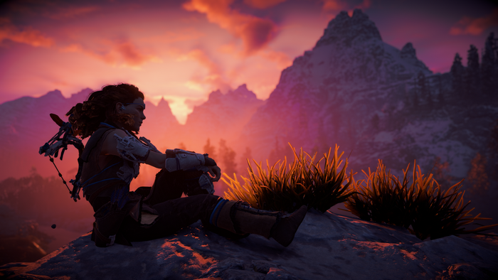 Aloy from Horizon Zero Dawn sitting on a mountain at sunset