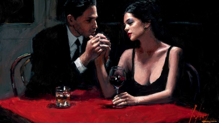 Couple holding hands at a table with wine