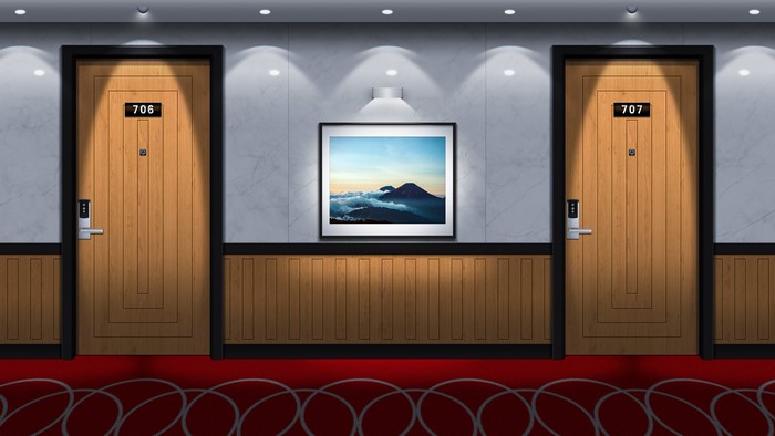Hotel hallway with two doors and a painting