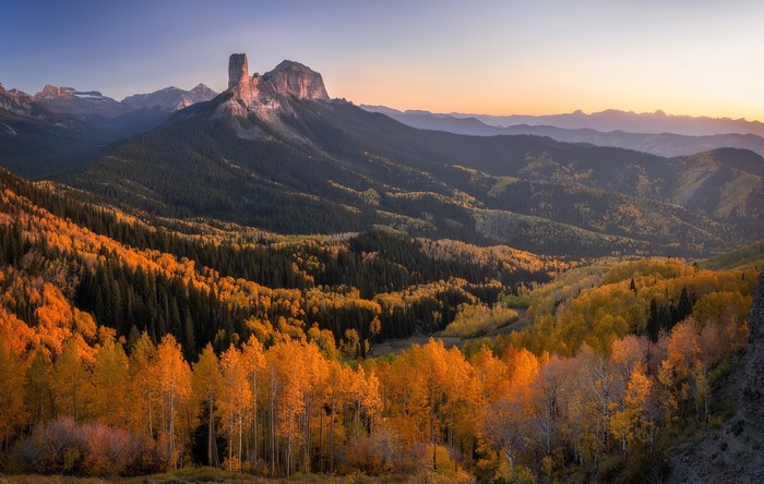 Mountain landscape with fall foliage at sunset