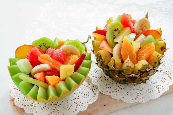 Fruit salad in pineapple and melon bowls