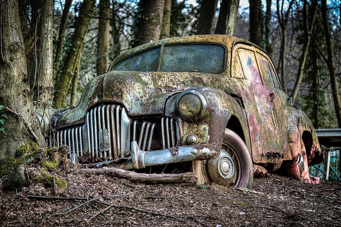 Abandoned vintage car in a forest