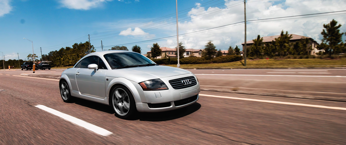 Silver Audi TT driving on a road