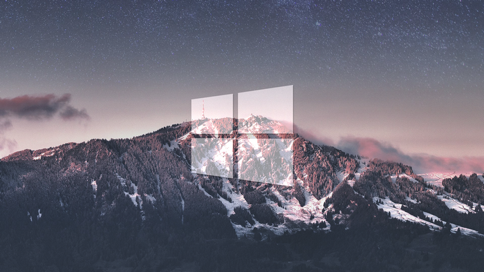 Microsoft Windows 10 logo over snowy mountains