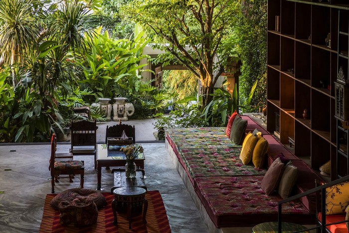 Interior living room with tropical plants and furniture