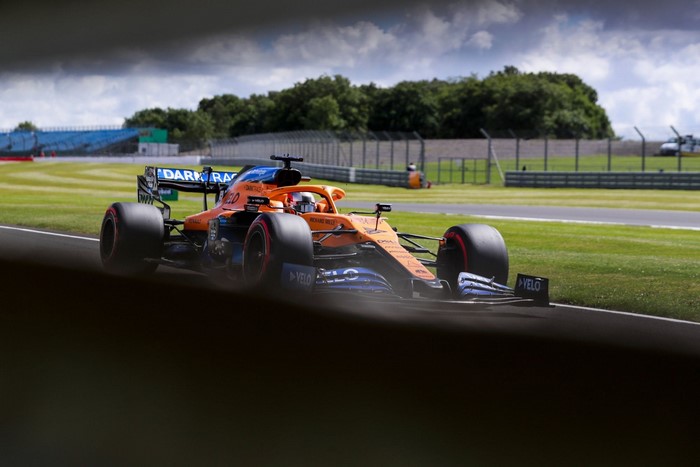 Carlos Sainz Jr. driving a McLaren F1 car on a race track