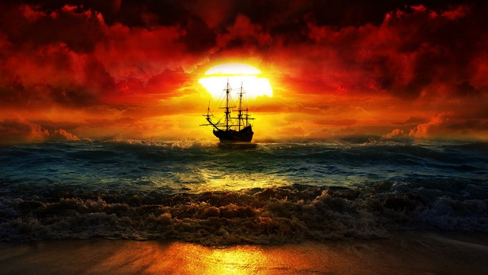 Sailing ship on the ocean at sunset