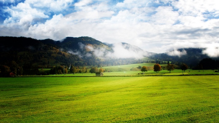 Green Meadow with Mountains and Clouds