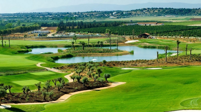 Golf course with a lake and surrounding landscape