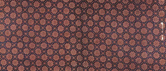 Dark blue fabric with repeating floral geometric pattern