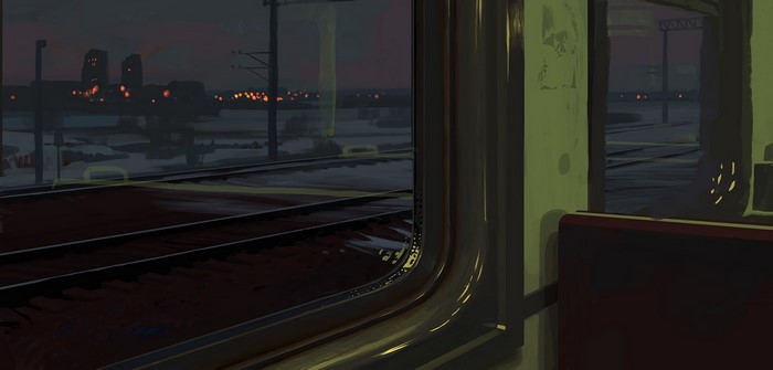 Train tracks at dusk with distant town lights
