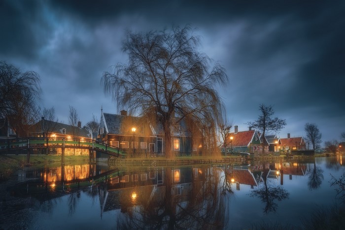 Night reflection of houses and trees in Zaanse Schans, Netherlands