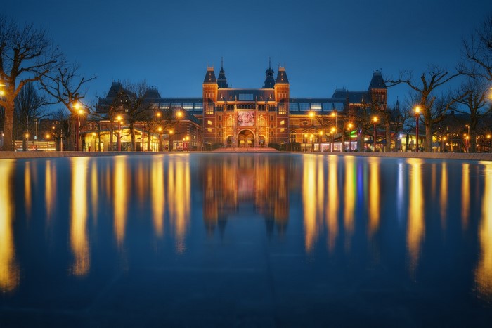 Rijksmuseum at night with reflection in water