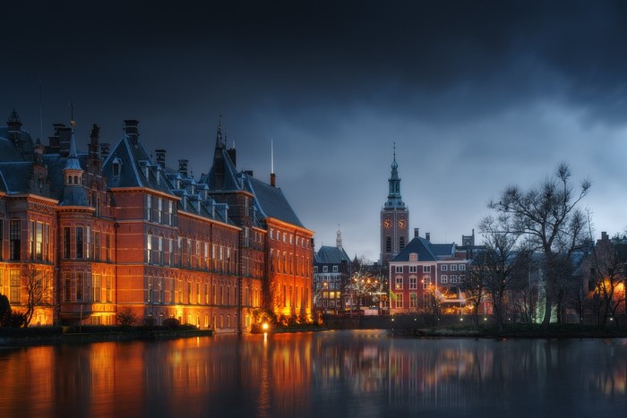 Cityscape with buildings and water at night
