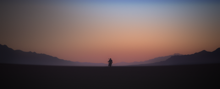 The Mandalorian in a desert landscape at sunrise