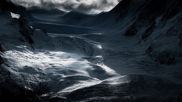 Snowy mountains under dramatic clouds