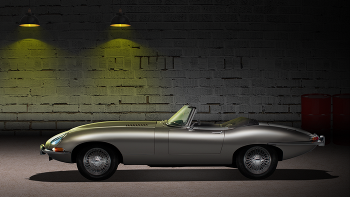Silver Jaguar E-Type convertible in a garage
