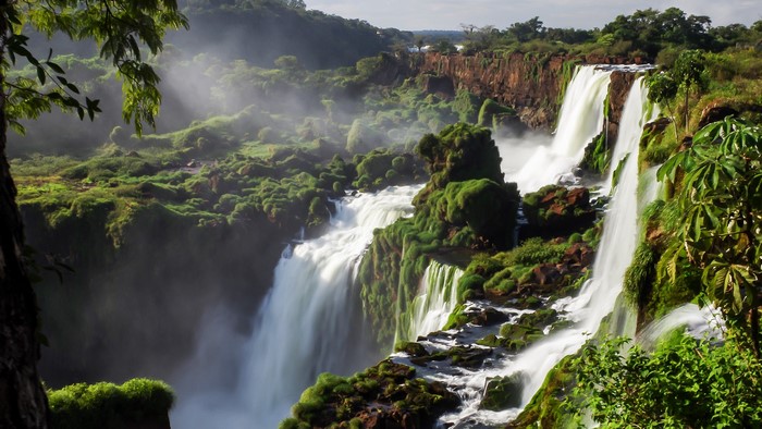 Waterfalls in a lush green jungle landscape