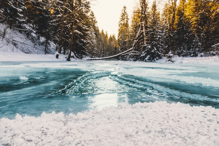 Frozen river in a snowy forest
