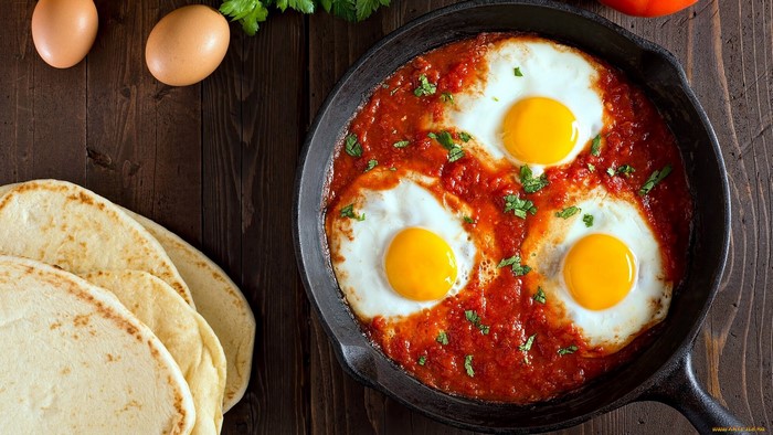 Shakshuka with eggs and flatbread