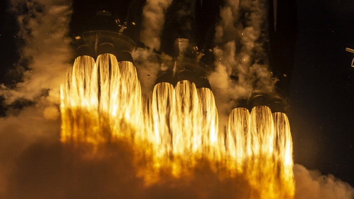 Rocket engines firing with bright yellow flames and smoke